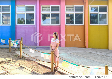 Colorful school building and female teacher concept 47874158