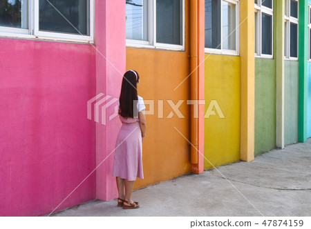 Colorful school building and female teacher concept 47874159