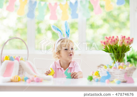 Kids on Easter egg hunt. Children dye eggs. Kids on Easter egg hunt. Children dye eggs. 47874676