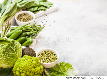 Assorted green toned raw organic vegetables Assorted green toned raw organic vegetables 47875512