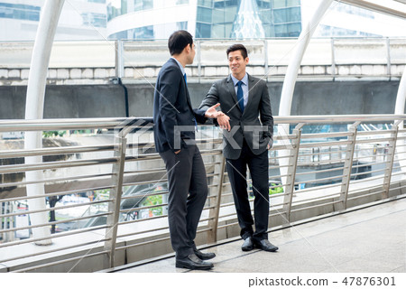 Asian businessmen talking together on a day break 47876301