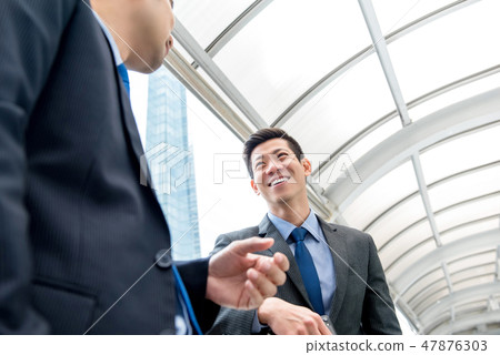 Asian Chinese businessman talking with partner 47876303