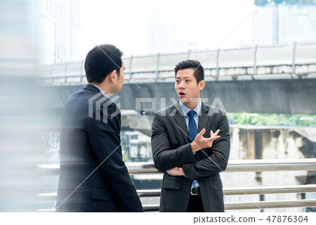 Asian businessmen talking together on a day break 47876304