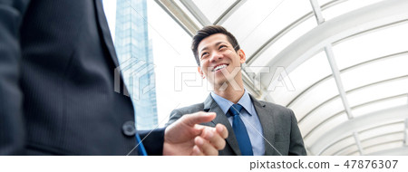 Asian Chinese businessman talking with partner Asian Chinese businessman talking with partner 47876307