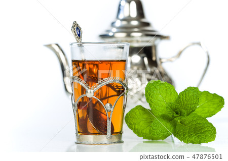 Traditional arabic mint tea in the typical glass Traditional arabic mint tea in the typical glass 47876501