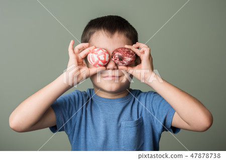 A little boy holding a Easter eggs A little boy holding a Easter eggs 47878738