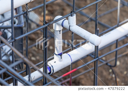 Newly Installed PVC Plumbing Pipes and Steel Rebar 47879222