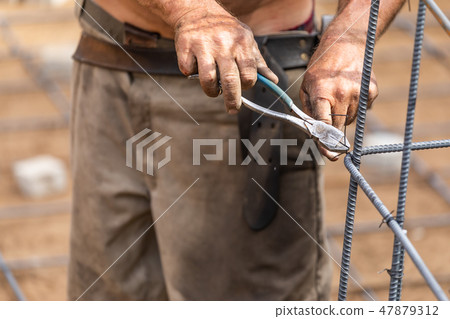 Worker Fixes Steel Rebar With Wire Plier Cut Tool 47879312