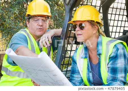 Male and Female Contractors at Construction Site Male and Female Contractors at Construction Site 47879405