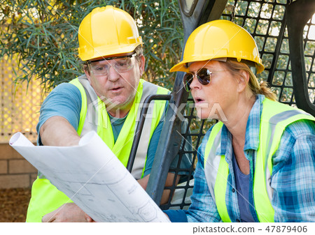 Male and Female Contractors at Construction Site Male and Female Contractors at Construction Site 47879406