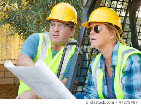 Male and Female Contractors at Construction Site Male and Female Contractors at Construction Site 47879407