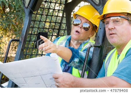 Male and Female Contractors at Construction Site 47879408