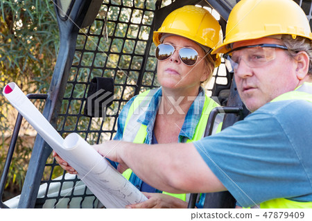 Male and Female Contractors at Construction Site Male and Female Contractors at Construction Site 47879409