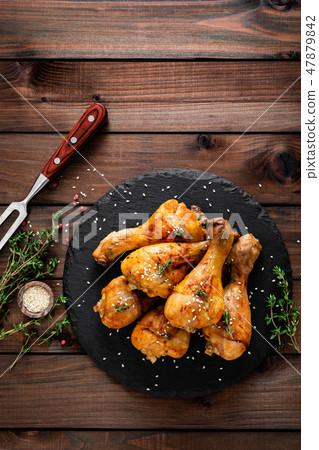 Grilled chicken legs on wooden background 47879842