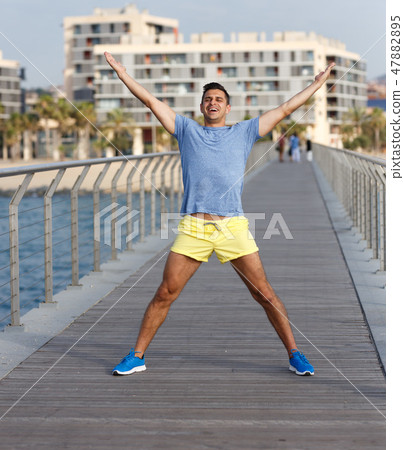 Sporty man posing outdoors Sporty man posing outdoors 47882895
