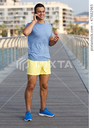 Athletic man talking by phone Athletic man talking by phone 47882965
