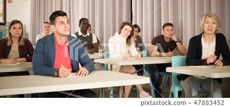 Adult students listening in classroom 47883452