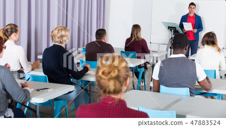 Students with teacher studying in classroom 47883524