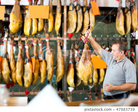 Male client choosing Spanish jamon 47883739
