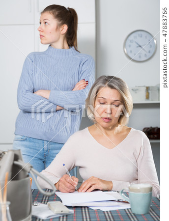 Woman quarreling with mother for documents 47883766