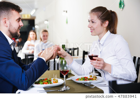 Gentleman with elegant woman are having dinner in luxury restaurante Gentleman with elegant woman are having dinner in luxury restaurante 47883941