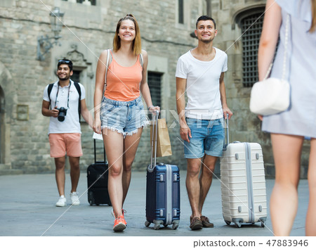 Adult couple in shorts with luggage Adult couple in shorts with luggage 47883946