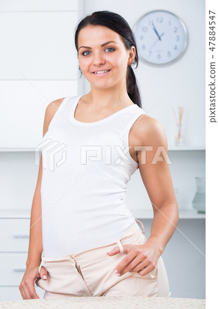 Young brunette woman in white Young brunette woman in white 47884547