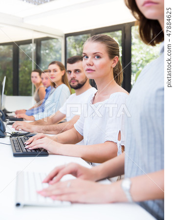 Side view of row of happy people working 47884625