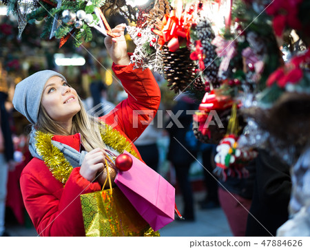 Girl shopping Christmas decorations 47884626