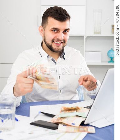 Male manager is calculating earning Male manager is calculating earning 47884886