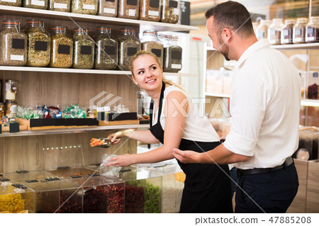 Seller and customer in store of ecological goods. Seller and customer in store of ecological goods. 47885208