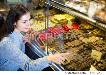 woman selecting chocolates 47885239