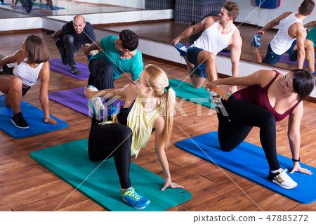 Positive people practicing yoga 47885272