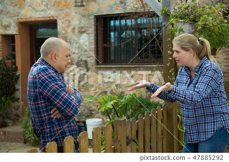 Woman quarreling with male neighbor Woman quarreling with male neighbor 47885292