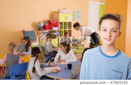 Schoolboy standing, elementary age children drawing at class 47885295