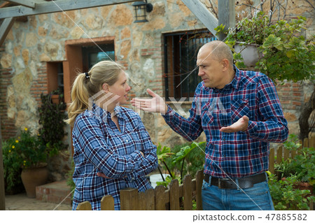 Spouses quarreling in backyard Spouses quarreling in backyard 47885582