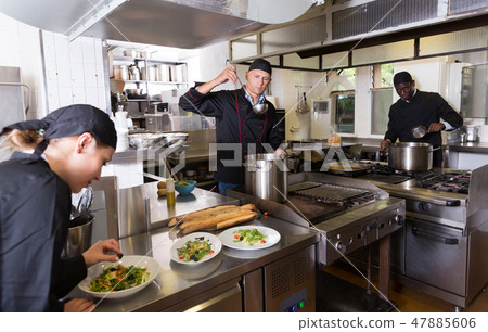 Chef with team preparing food 47885606