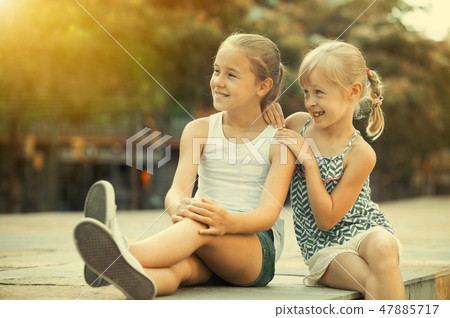 Two girls looking into distance outdoors 47885717