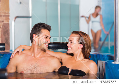 Couple is resting in pool in time spa-day Couple is resting in pool in time spa-day 47885727