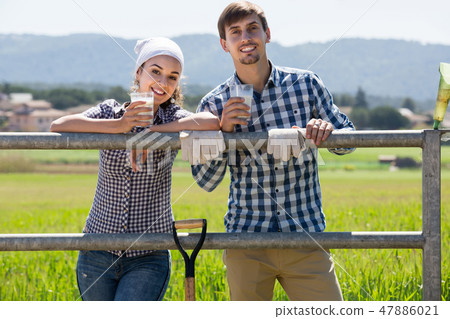 man and woman chatting and enjoying milk outdoors man and woman chatting and enjoying milk outdoors 47886021