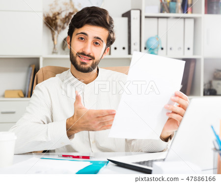 Office worker holding paper with contract Office worker holding paper with contract 47886166