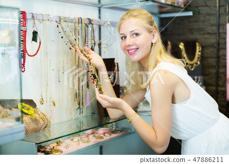 Woman buying long necklace Woman buying long necklace 47886211