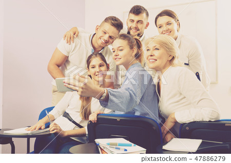 Students with female teacher making selfie indoors Students with female teacher making selfie indoors 47886279