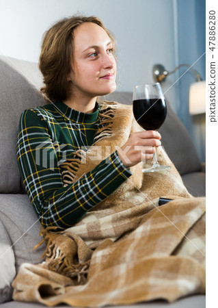 Woman relaxing with wine at home Woman relaxing with wine at home 47886280
