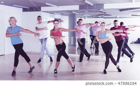 Group of happy people of different ages dancing Group of happy people of different ages dancing 47886284