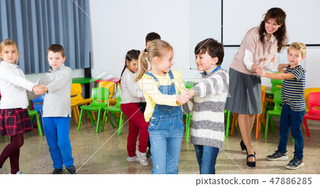 Kids and teacher dancing Kids and teacher dancing 47886285
