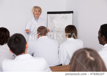 Female giving presentation for medics Female giving presentation for medics 47886287