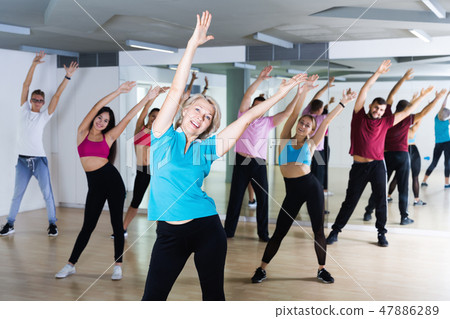 Group of smiling people of different ages dancing Group of smiling people of different ages dancing 47886289