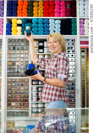 Woman holding yarn balls 47886290