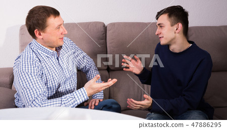 Guy with his father are resting and talking about teenage life Guy with his father are resting and talking about teenage life 47886295
